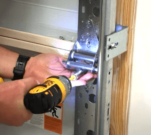Garage door hinge being replaced