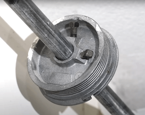 A close up of a cable drum from a sectional garage door.