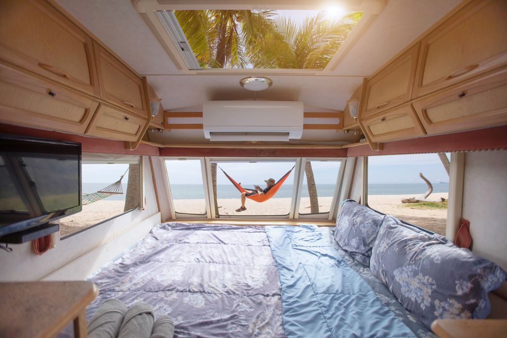 Inside a Camper Looking Out to a Beach Scene — Total Caravan Repairs in Nabiac, NSW