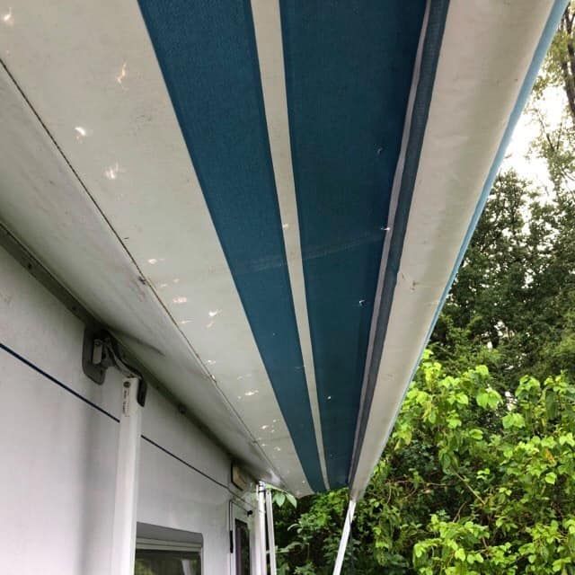 Blue and White Striped Awning Extended From a White Camper — Total Caravan Repairs in Taree, NSW
