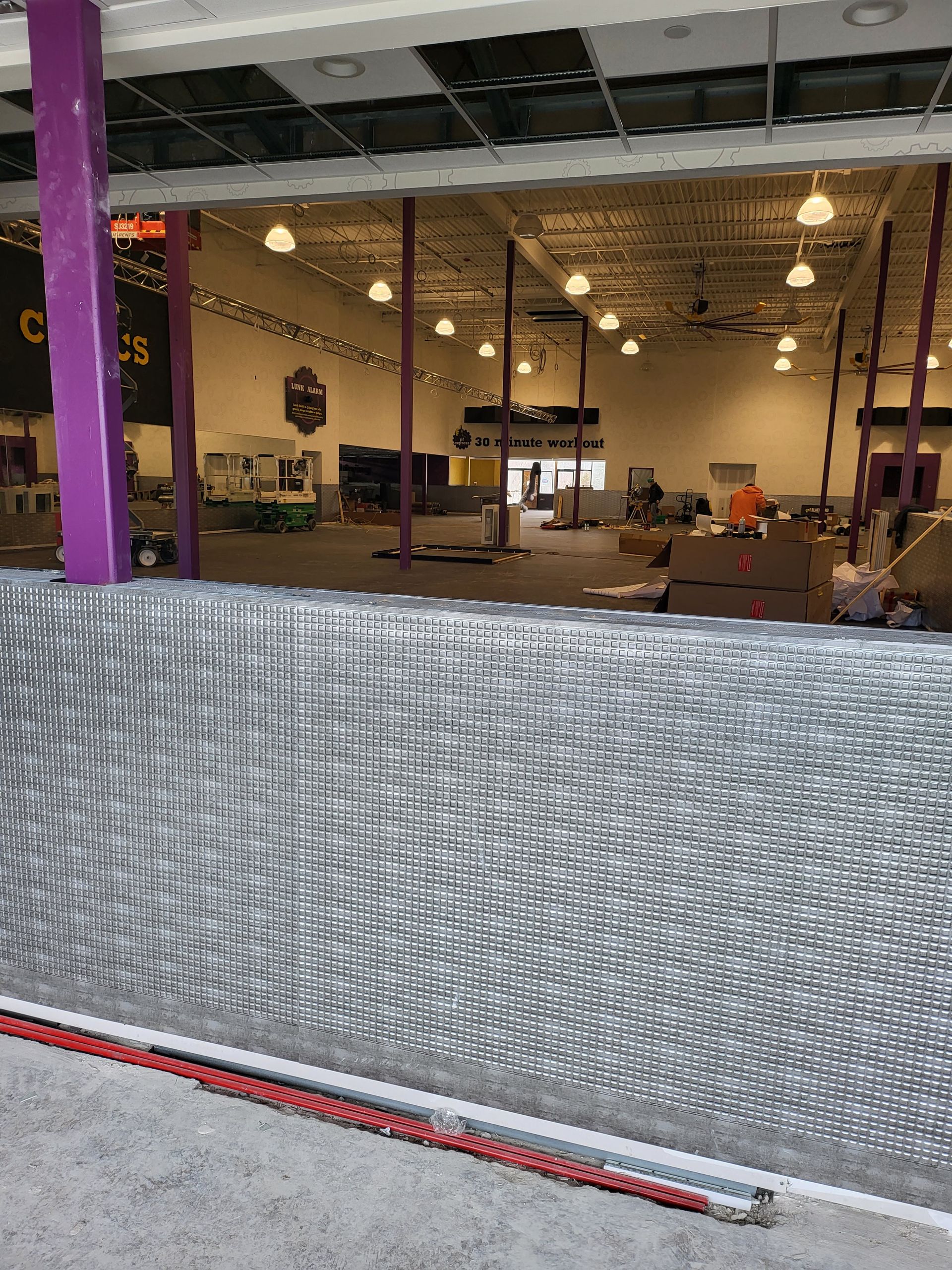View inside a large, open space with construction.
