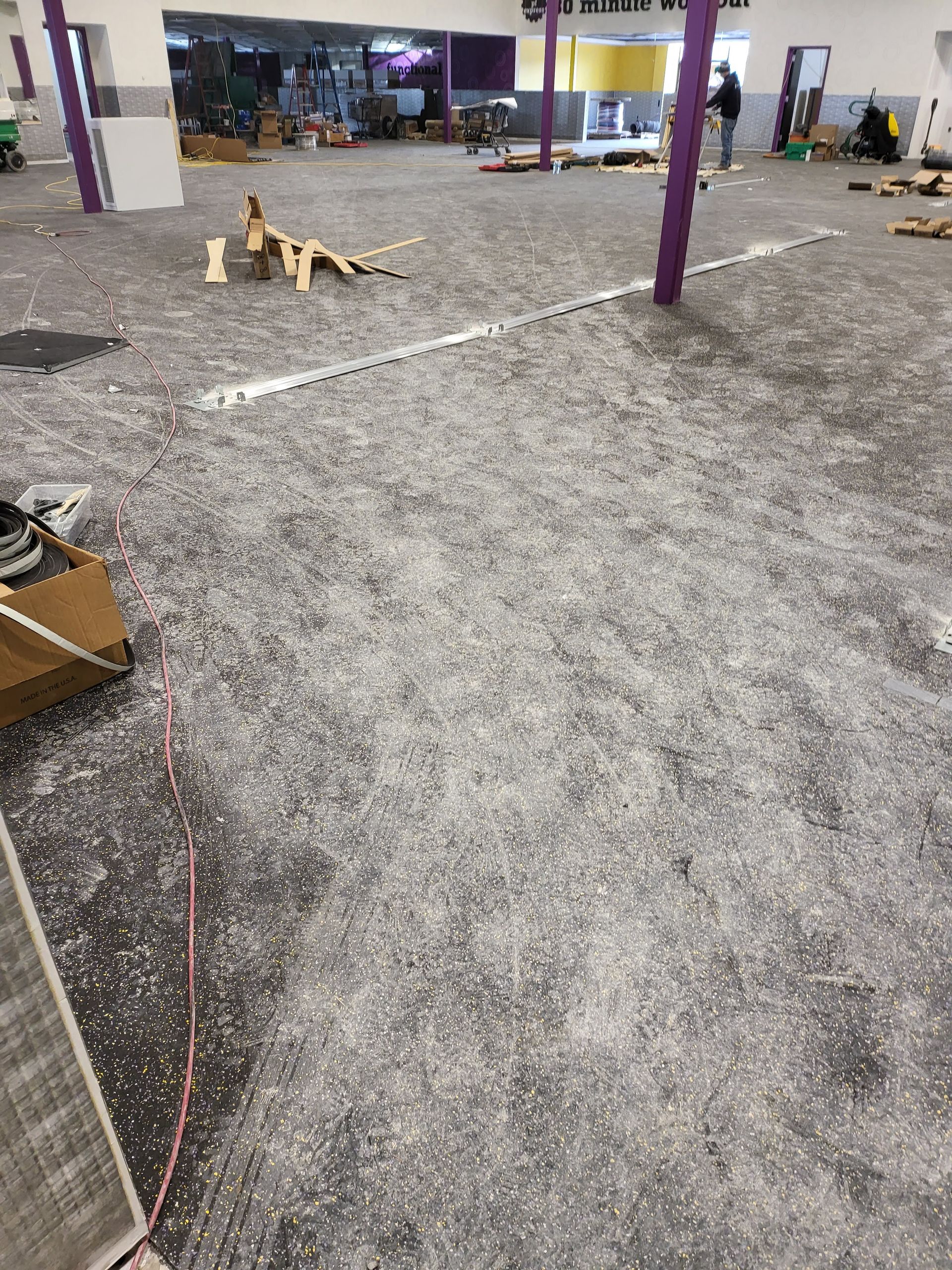 Open interior space with scattered gray material on floor.