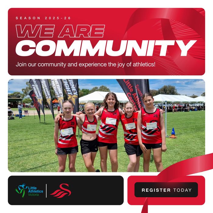 Five girls in red athletic uniforms smile on a green field,