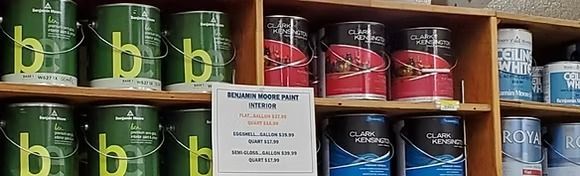 Shelves of colorful canned goods with a white “Sugar Nook” sign in the center