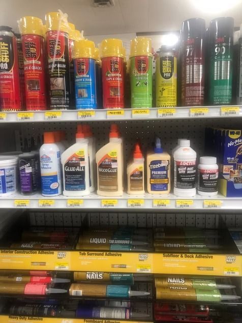 Auto parts store shelf with colorful spray cans and bottles of car care products
