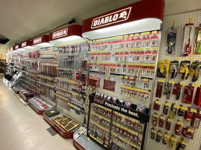 Hardware store aisle with Diablo power tool accessories and drill bits displayed on wall racks
