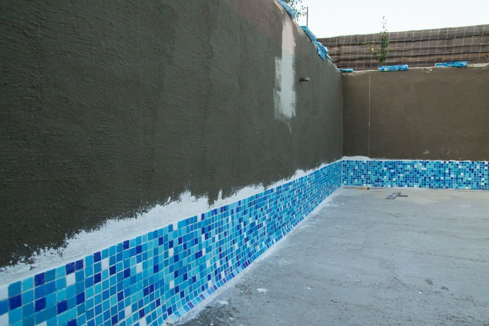 A Swimming Pool is Being Built and the Tiles Are Being Installed — Accurate Tiling MNC In Dunbogan, NSW