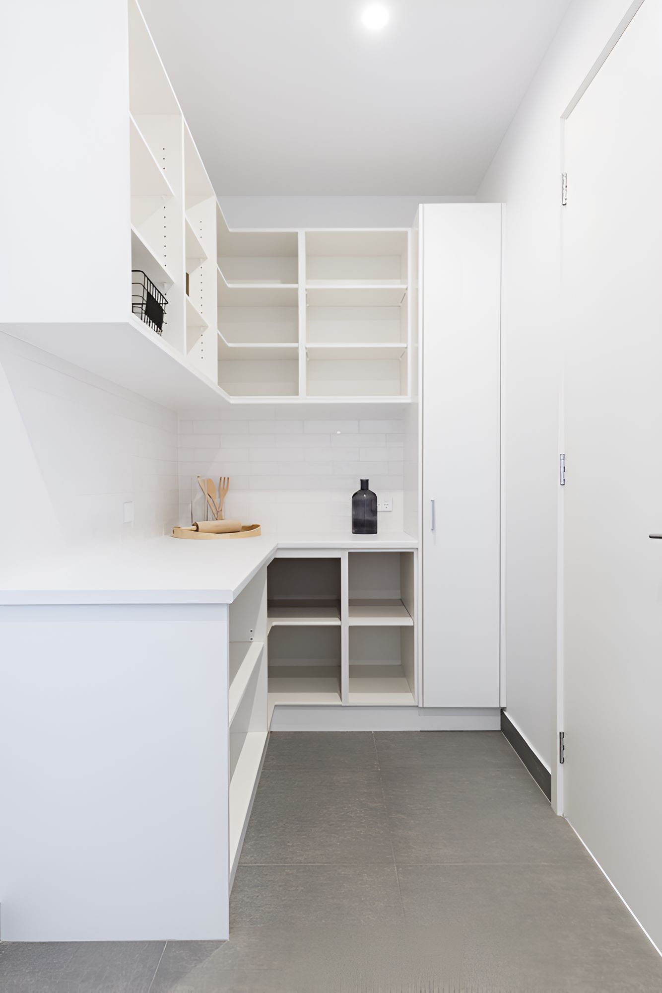 A Laundry Room With White Cabinets and Shelves and a Desk — Accurate Tiling MNC In Dunbogan, NSW