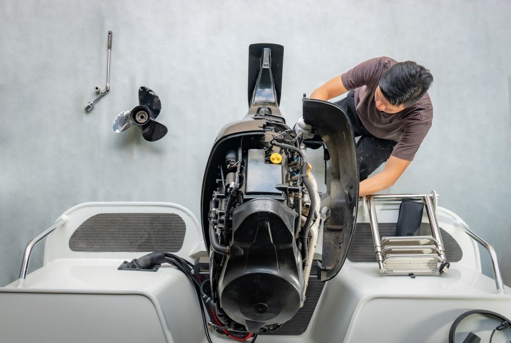 Mechanic Inspecting a Boat’s Outboard Motor — McCabbin Marine In Airlie Beach, QLD