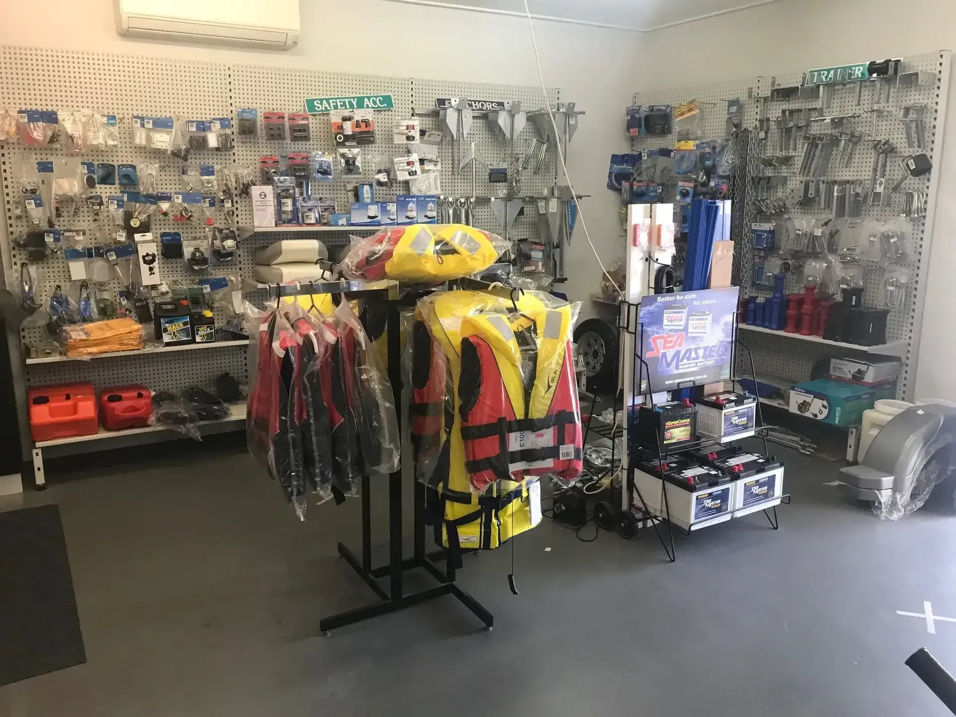 Safety Gear Display in A Retail Shop, with Vests and Helmets on Racks — McCabbin Marine In Bowen, QLD