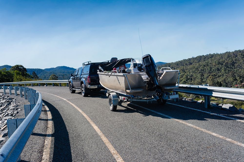 Truck Towing a Boat on A Curving Mountain — McCabbin Marine In Airlie Beach, QLD