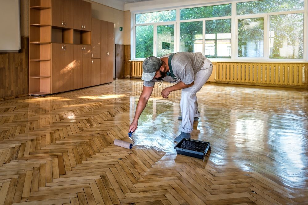Two Men is Cleaning a Carpet — John Chisholm Flooring in Manunda, QLD
