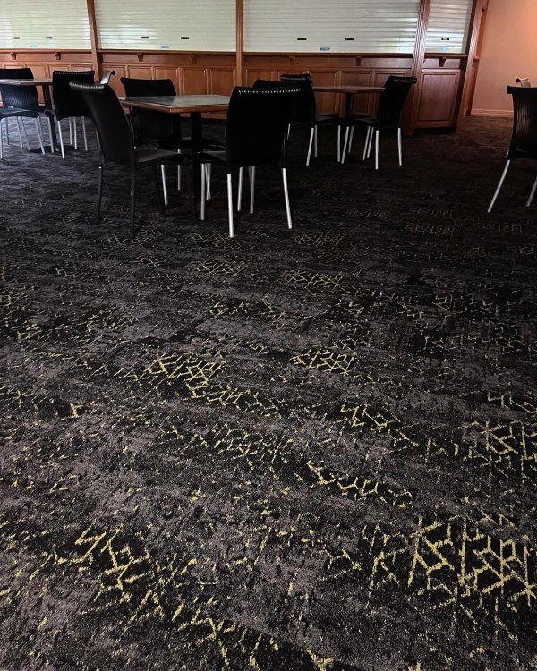 A Room With Tables and Chairs on the Floor — John Chisholm Flooring in Manunda, QLD