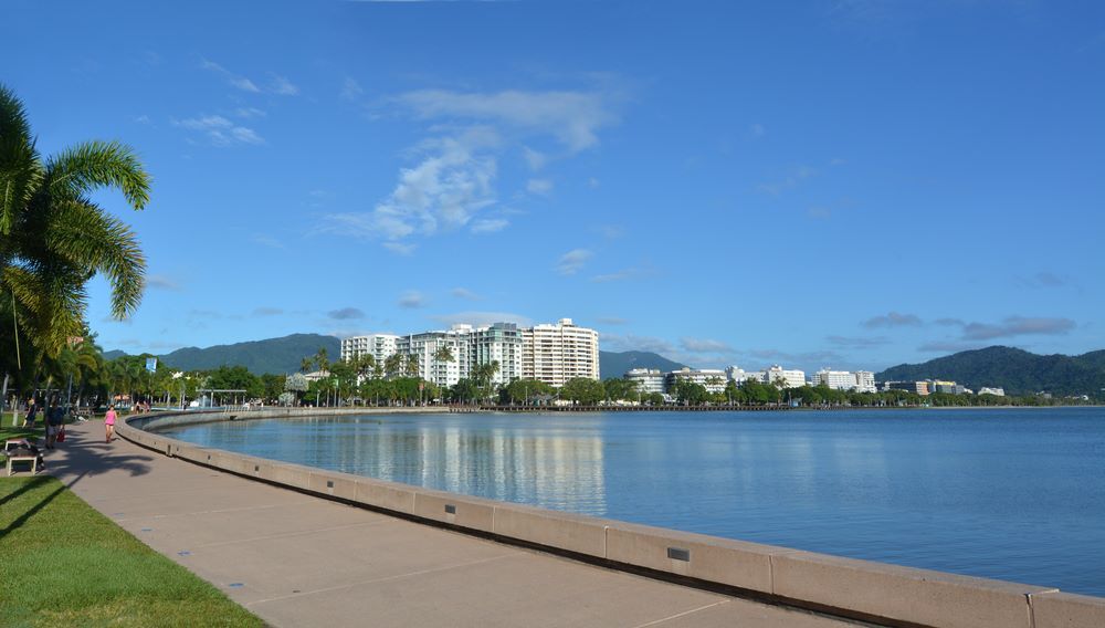A Large Body of Water With a City in the Background — John Chisholm Flooring in Cairns, QLD