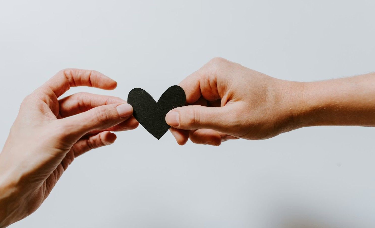 Hands holding a heart symbol representing compassionate guidance for meaningful farewells in Schiller Park, IL