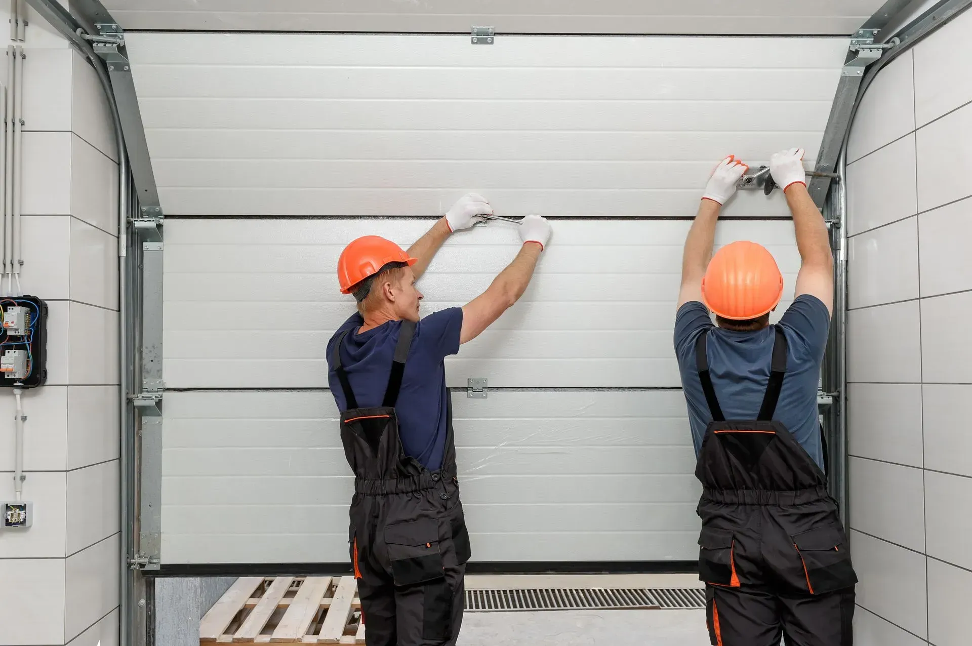 An empty garage with a garage door open and a garage door opener.