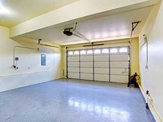 A large house with a white garage door and a black roof