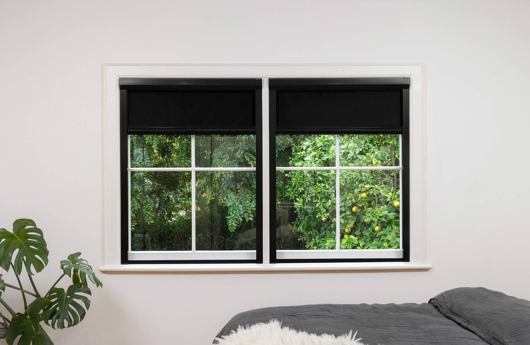 Black frame and black fabric full blackout blinds for dual narrow windows, inside installation.