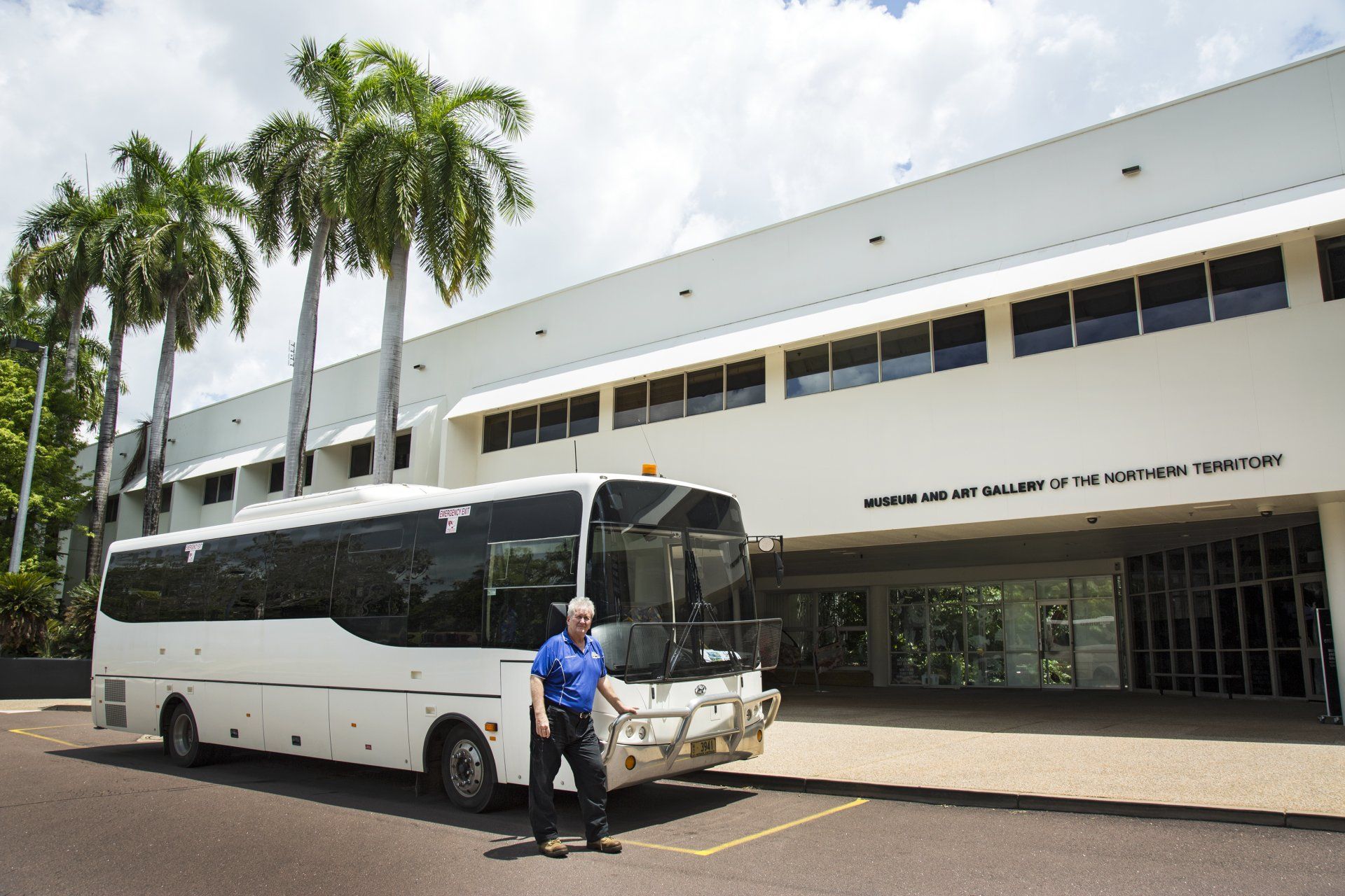 Coach Charters Australia coach and driver ready for delegate transport in Darwin