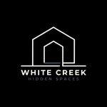 White Creek Hidden Spaces logo with a white house outline on a black background