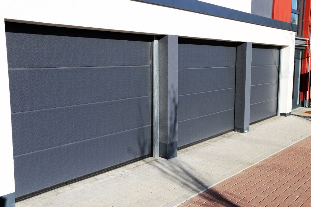 A Row of Garage Doors on the Side of a Building — Hastings Garage Door Services in Camden Haven