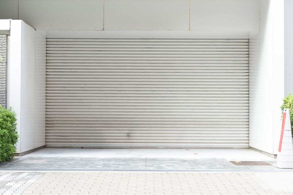 A White Garage Door is Closed and Empty — Hastings Garage Door Services in Port Macquarie