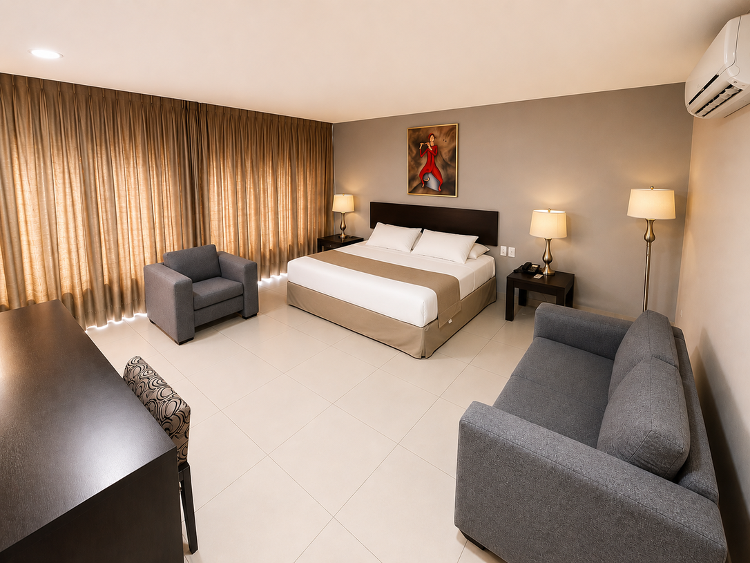 Una habitación de hotel con una cama grande y un cuadro en la pared.