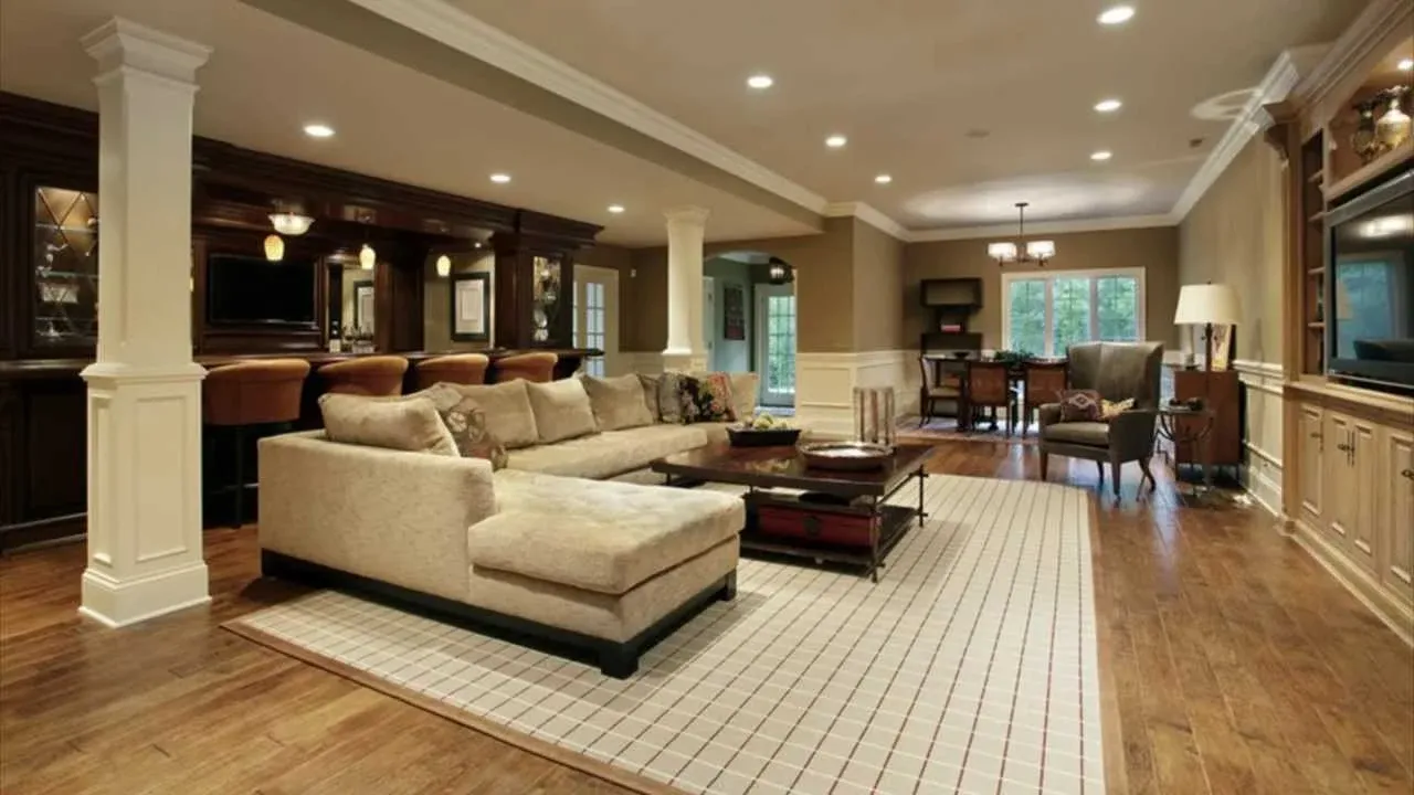 Upscale finished basement with a bar, seating area, and dining space; hardwood floors and recessed lighting.