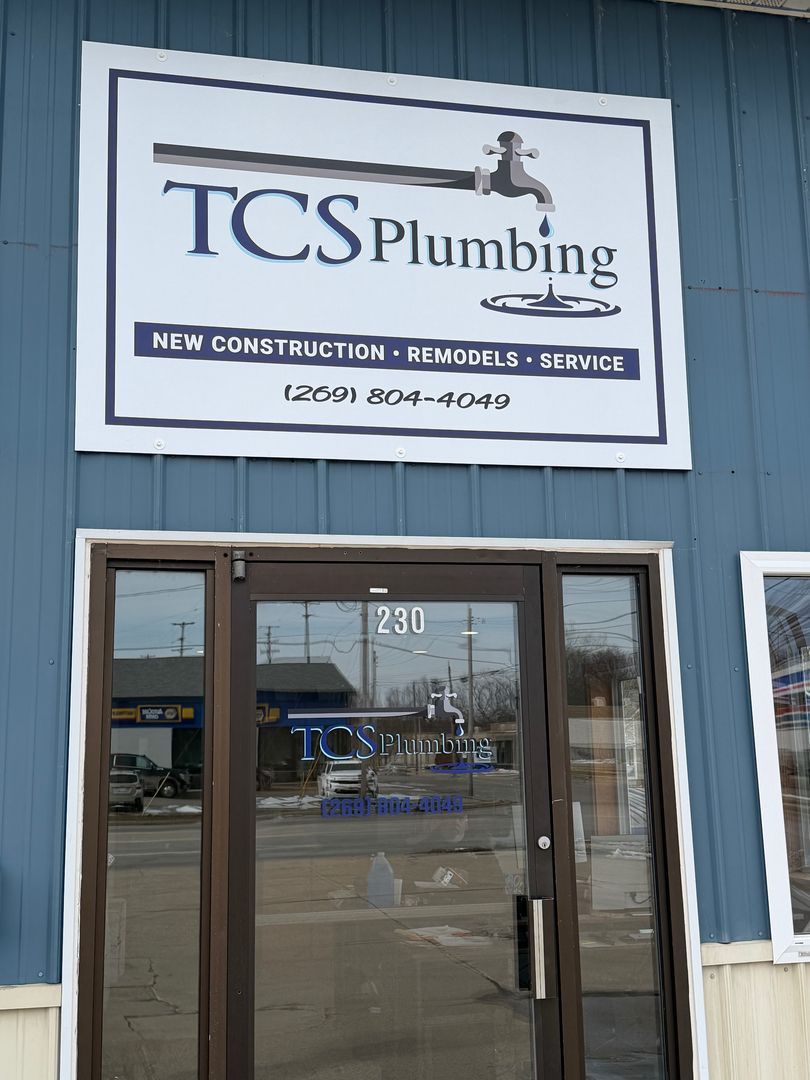 TCS Plumbing storefront with blue siding, glass door, and sign for new construction, remodels, and service