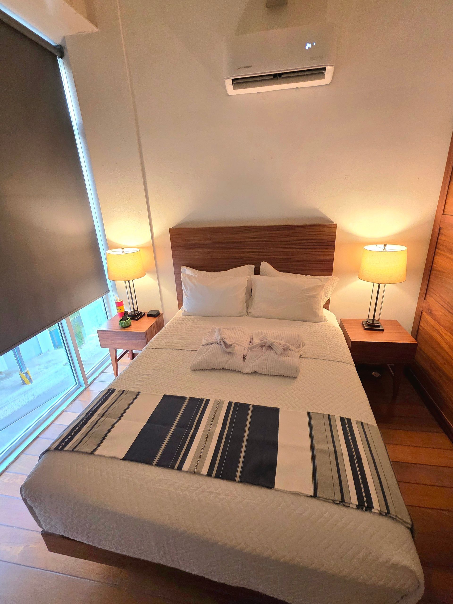 Queen bed and television in the Cove queen room at AVA19 in Puerto Vallarta