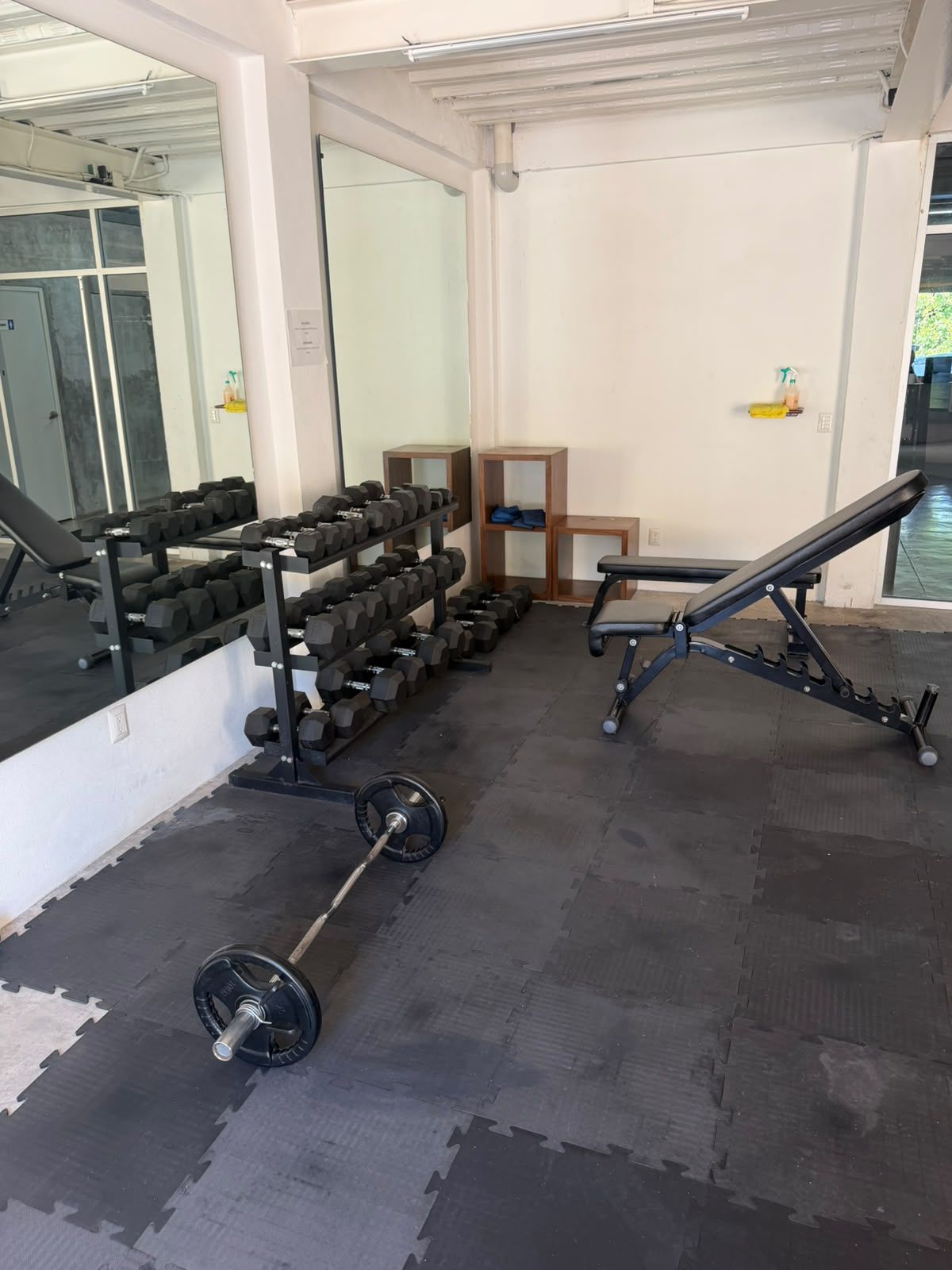 Exercise benches and mirrored wall in the AVA complex gym in Puerto Vallarta