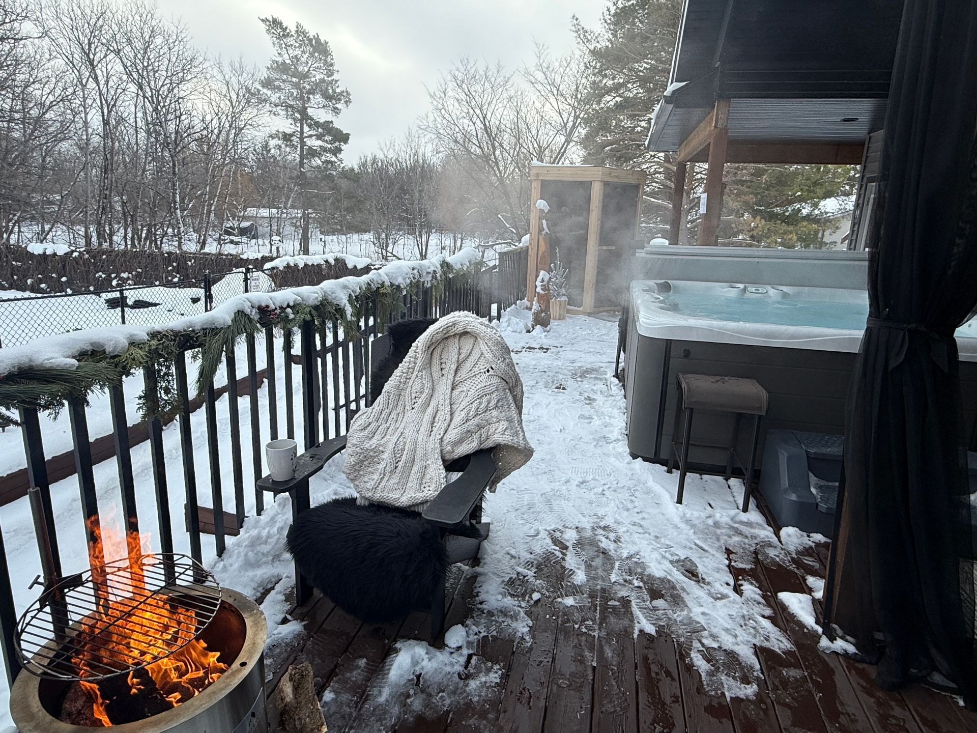 Winter outdoor seating and hot tub area at Stay549 Winnipeg