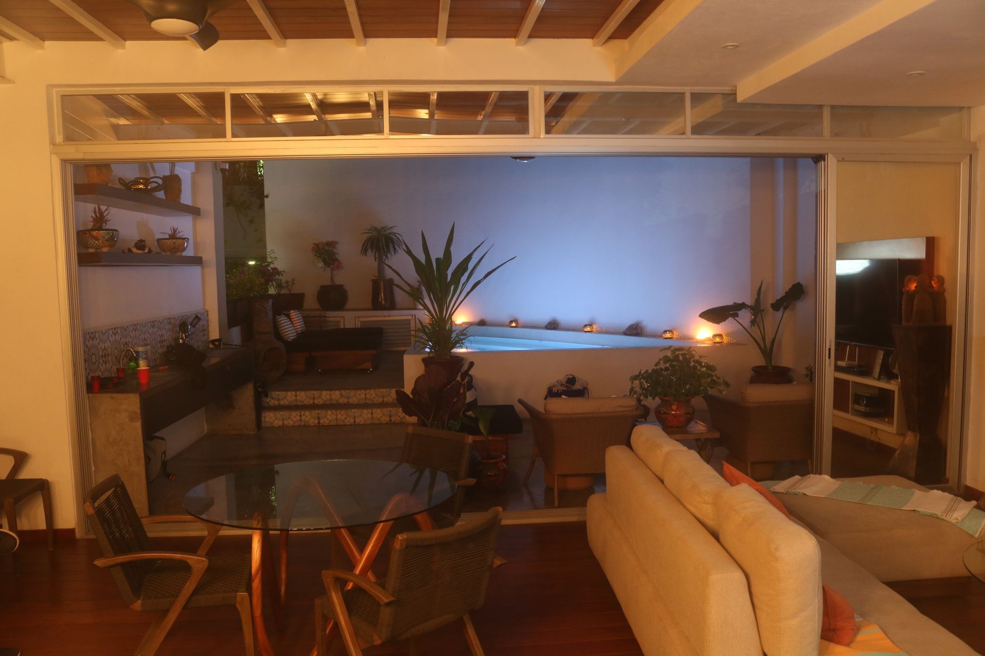 Living and dining area at dusk on the main floor of AVA19 in Puerto Vallarta