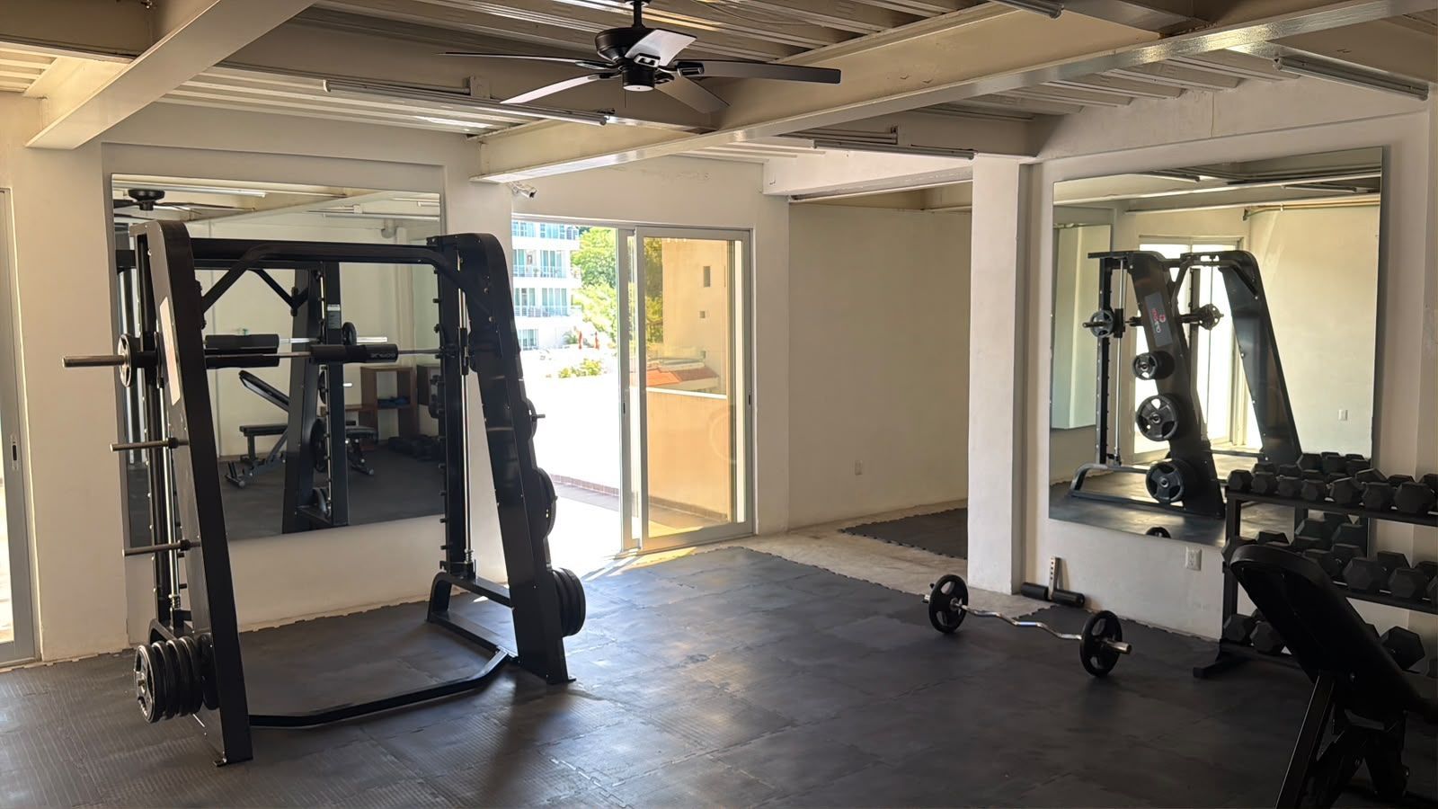 AVA complex gym with workout equipment, ceiling fans and natural light in Puerto Vallarta