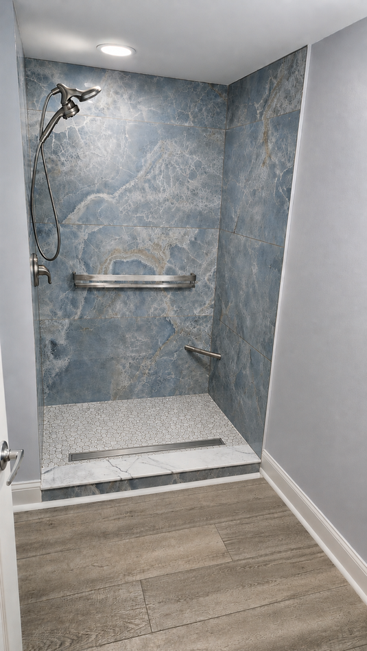 Walk-in shower with blue tile walls, grab bars, and a bench beside wood-look flooring.
