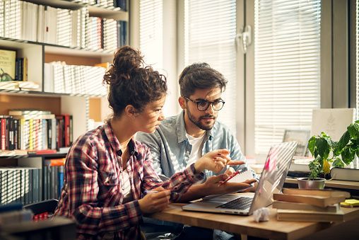 Two counselors collaborating on a college plan