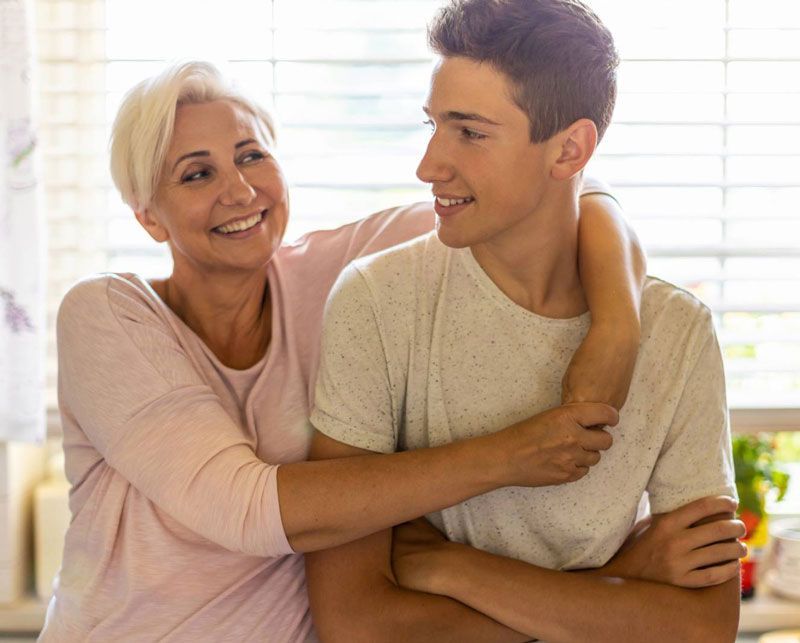 Mother and son embracing after college acceptance