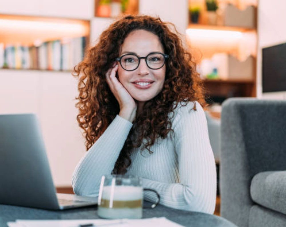 College counselor at her desk reviewing student progress