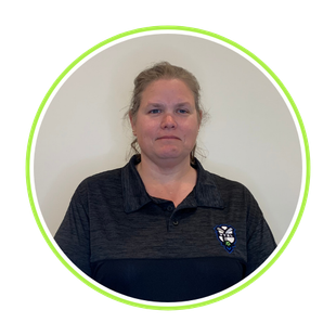 Person in a dark polo shirt standing against a plain wall, framed by a green circular border.