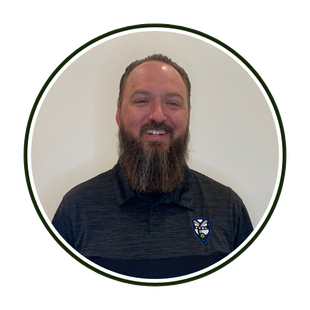 Smiling man with a beard in a dark shirt, centered in a circular portrait on a white background