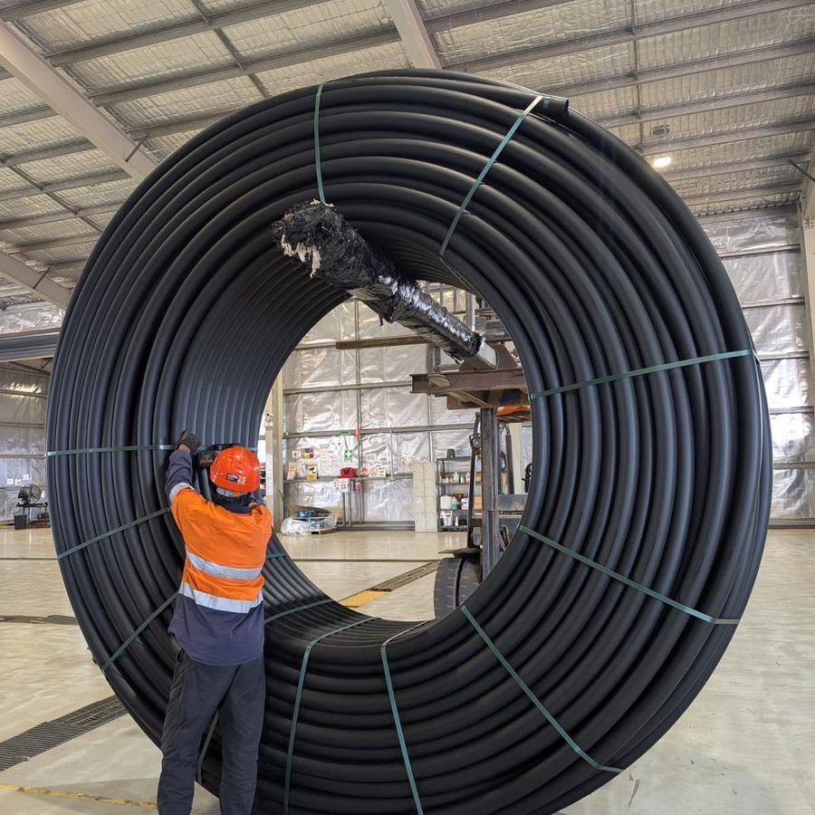 Large Elsam poly pipe coil with a team member for scale at the Livingstone plant