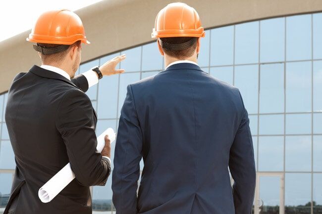 Two Employer Observing The Building — Building Assessments in Berrimah, NT