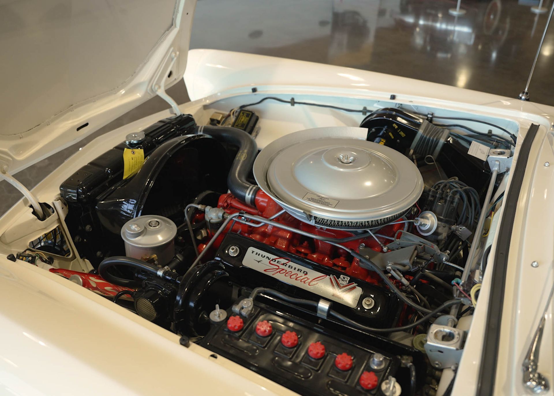 A close up of a car engine with the hood open