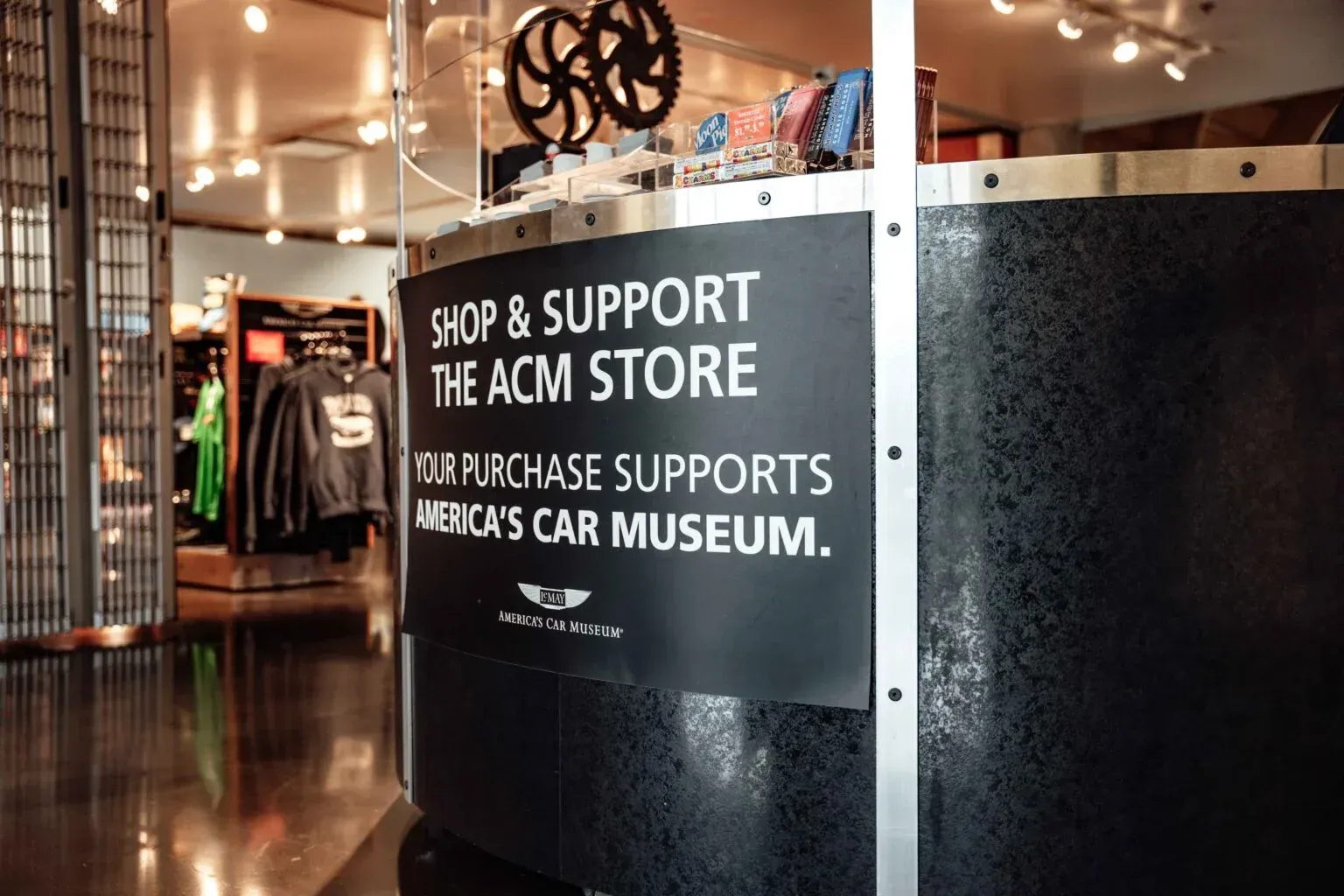A sign that says shop and support the acm store