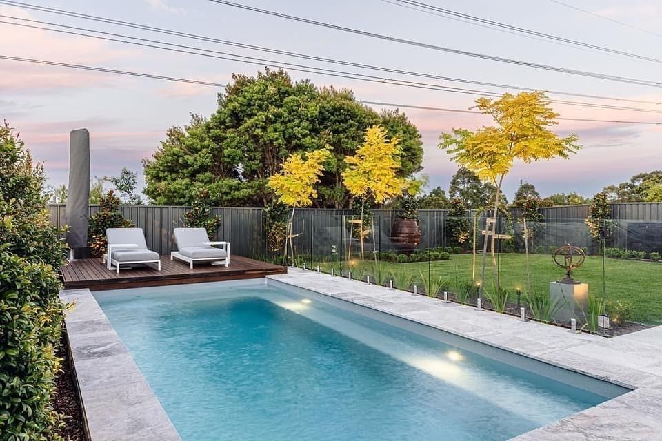Backyard Pool with Lounge Chairs and Trees at Sunset — New Vision Pools in Thrumster, NSW