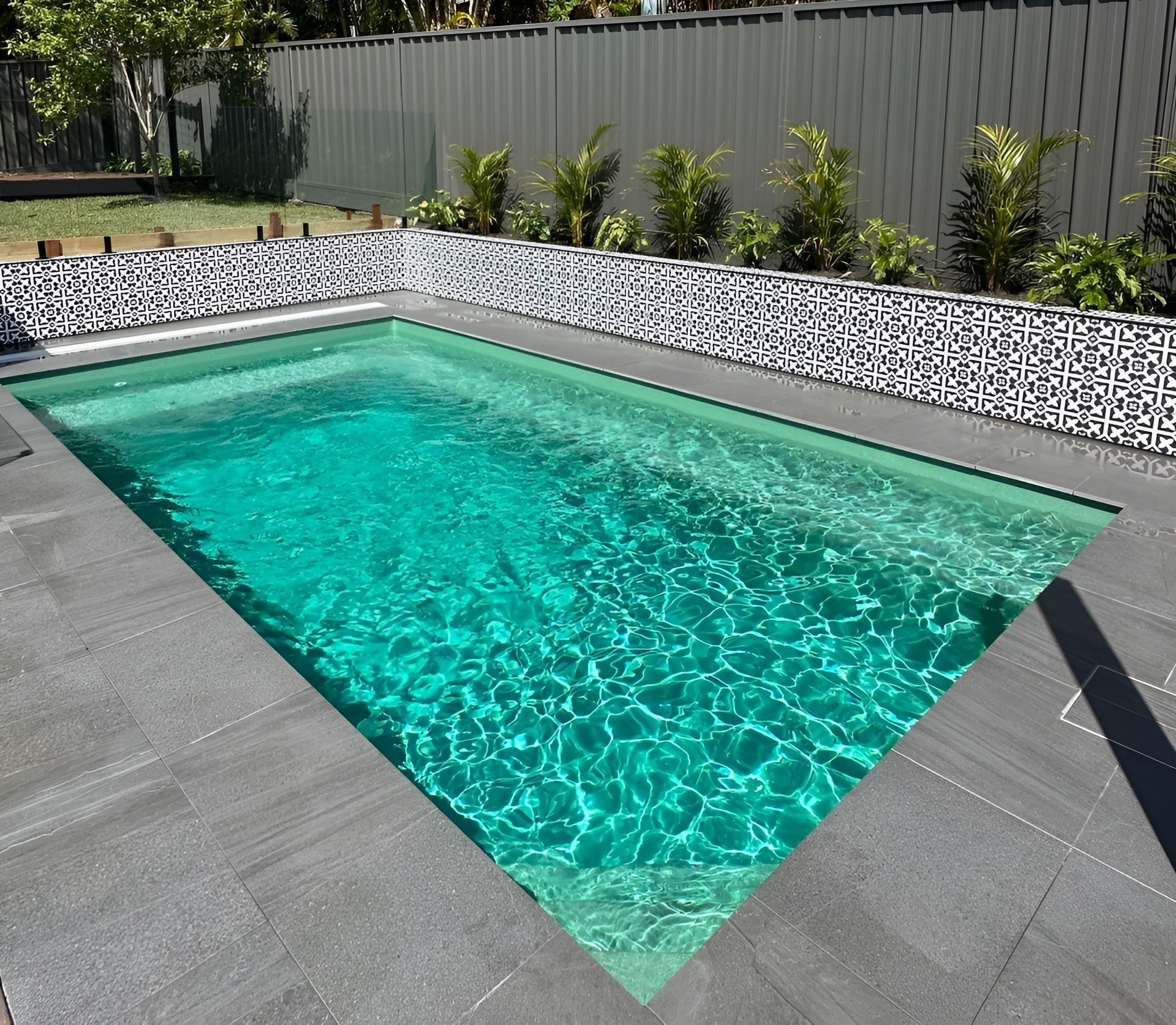 Small Turquoise Backyard Pool Surrounded by A Landscaped Fence Line — New Vision Pools in Lake Cathie, NSW