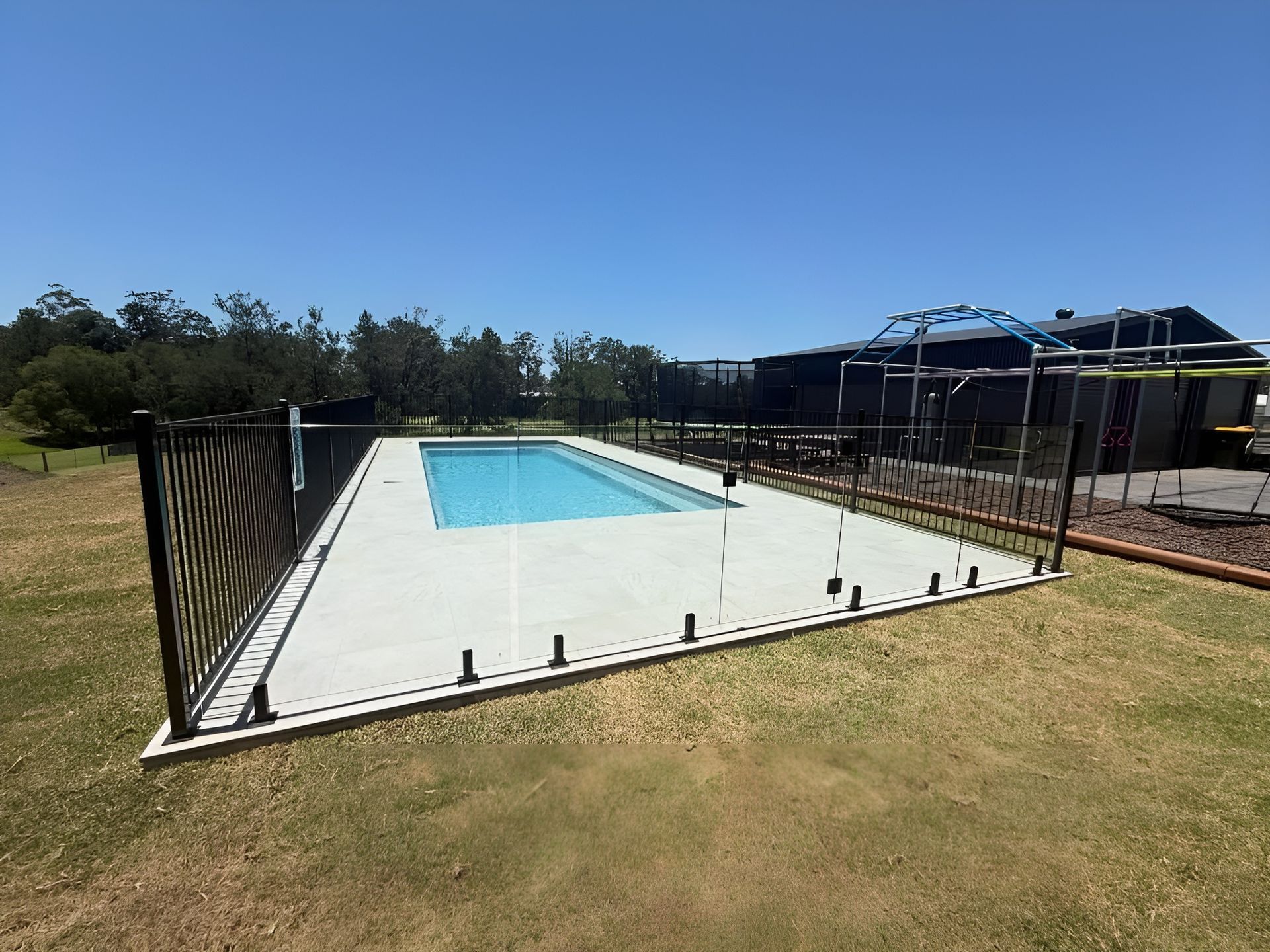 Outdoor Swimming Pool Under Construction Beside a Grassy Yard — New Vision Pools in Bonny Hills, NSW