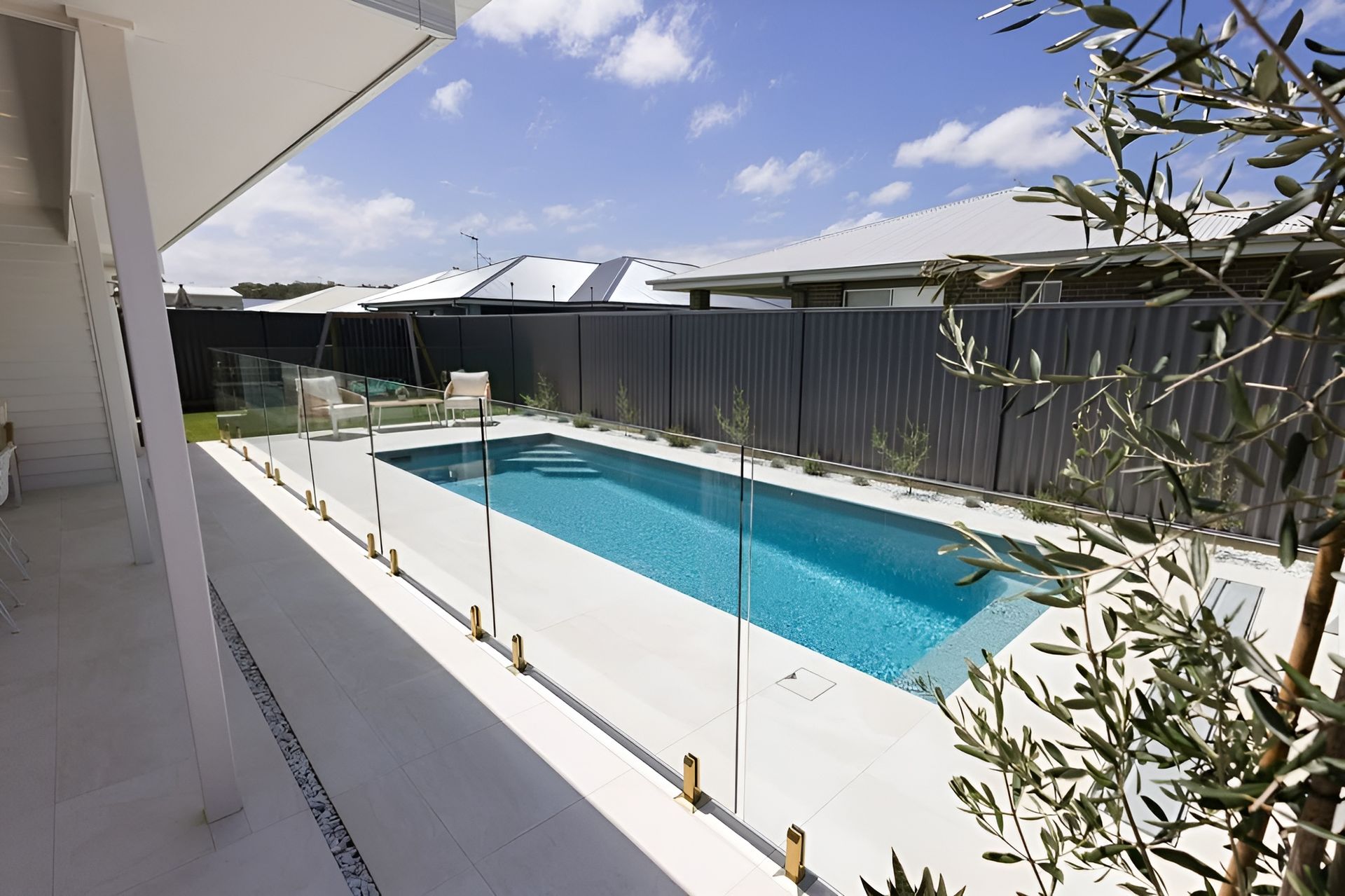 Backyard Swimming Pool with White Deck and Gray Privacy Fence — New Vision Pools in Lake Cathie, NSW