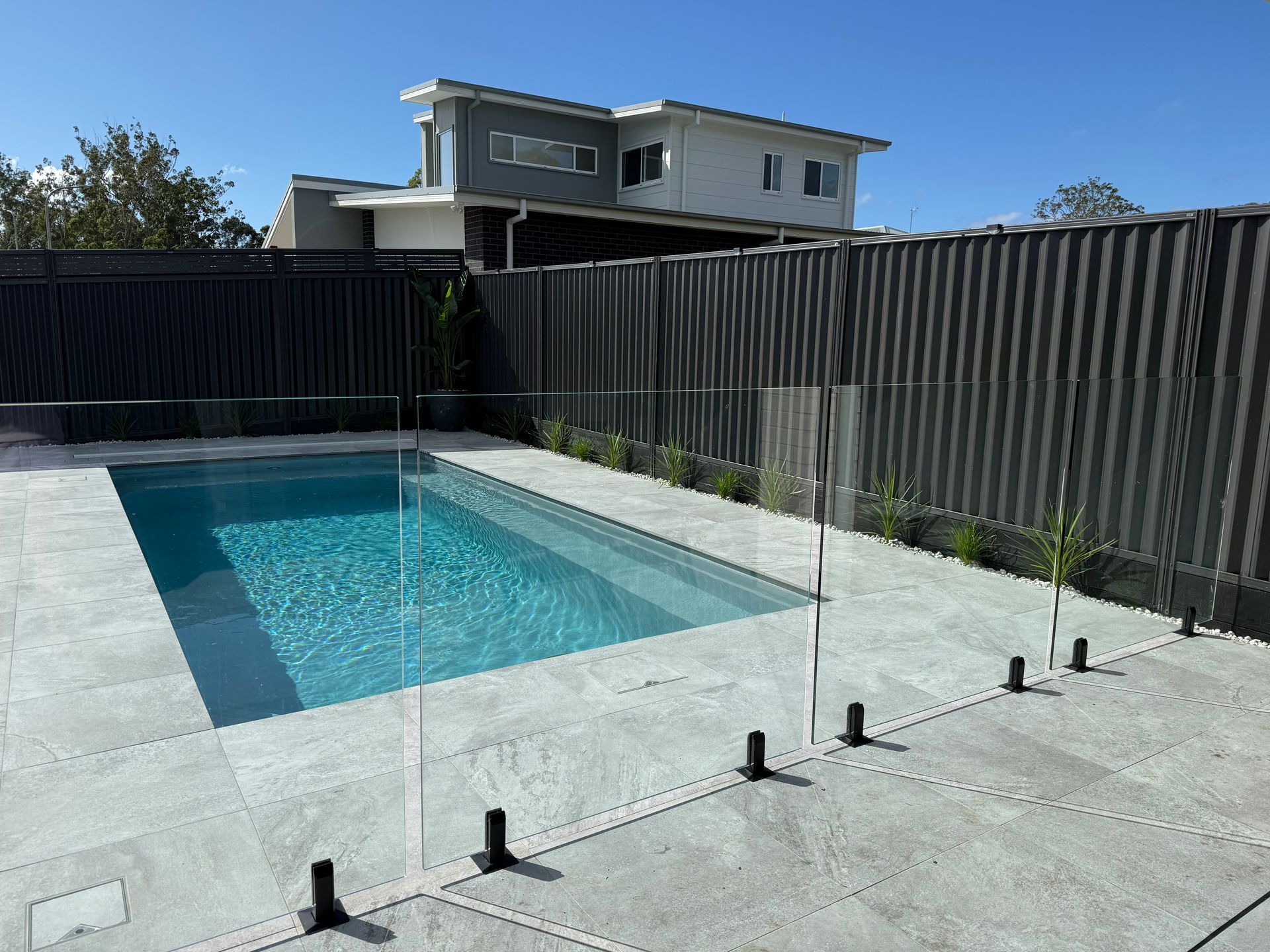 Empty Backyard Pool Under Construction with Concrete Deck and Black Fencing — New Vision Pools in Port Macquarie, NSW