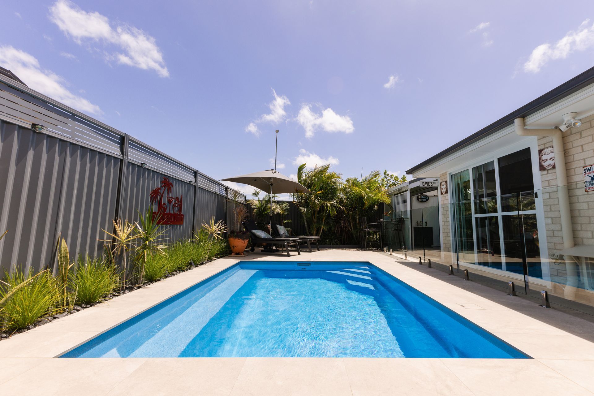 Backyard Pool Beside a Modern House with Glass Doors — New Vision Pools in Port Macquarie, NSW